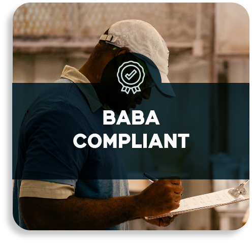 An inspector holding a compliance clipboard on the factory floor with a BABA Compliant text overlay.