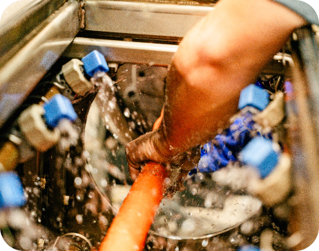 Close-up internal view of extrusion machinery processing a continuous orange micro-duct pipeline pathway.